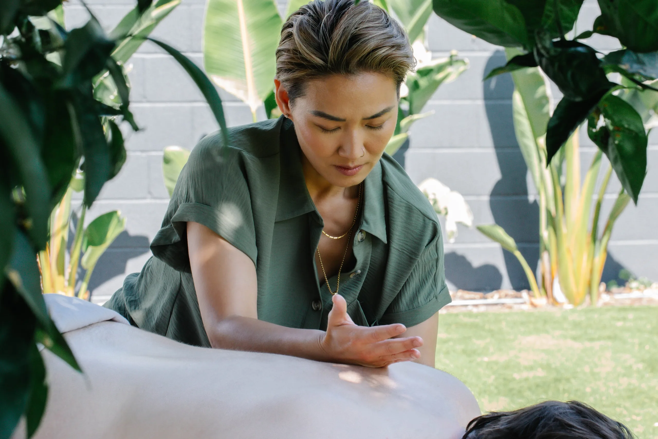 Angie Wong giving hands-on myofascial release in the garden at our Valley Village studio